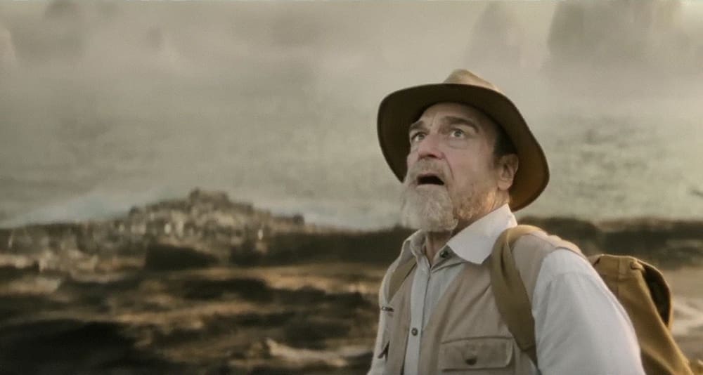 John Goodman (Bill Randa) stares in awe at a giant predatory creature.